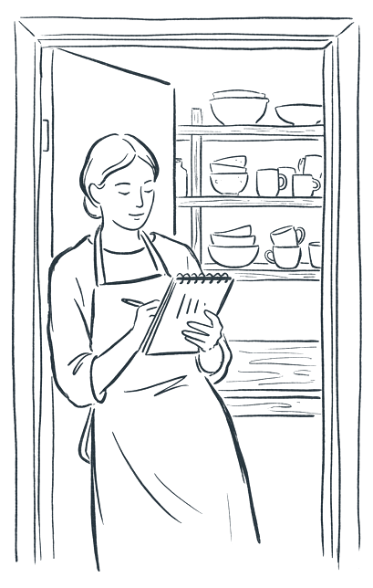 A potter in an apron in the doorway of a small studio, glancing at a notebook of tally marks.